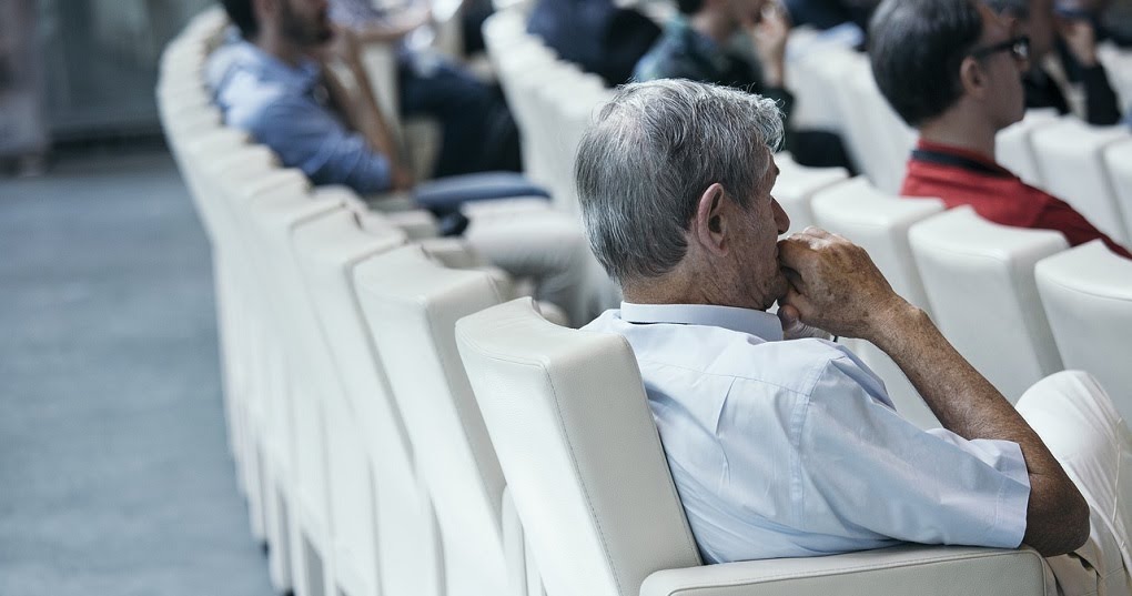 Man-hears-a-lecture-at-a-conference