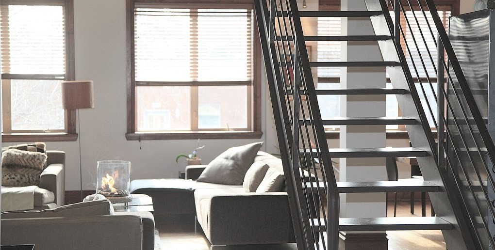 Apartment with numerous windows and stairs to the 2nd floor